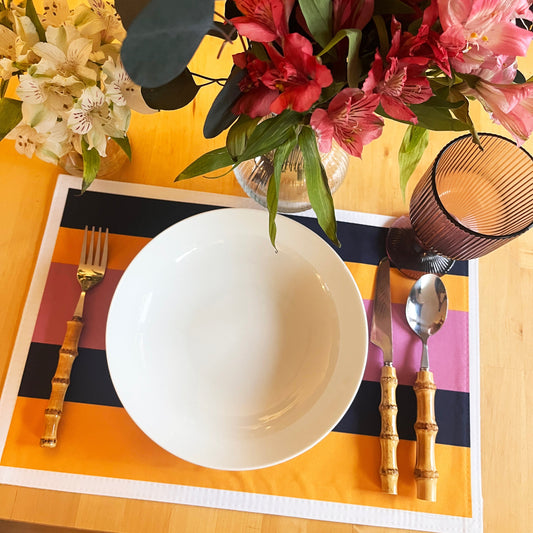 Layers Edit: Pink Layers colour-block placemat on a dining table with a white bowl and flowers