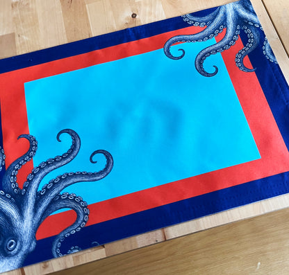 Placemat with blue octopus design on a red and blue border, with a detailed image.
