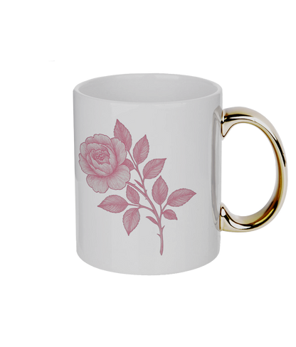 White mug with pink floral design and gold handle on a white background