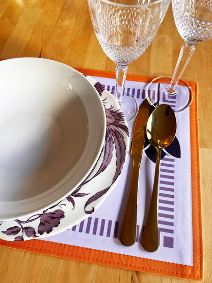 Dinner setting with a bowl, cutlery, and glasses on a placemat. Designed in the UK
